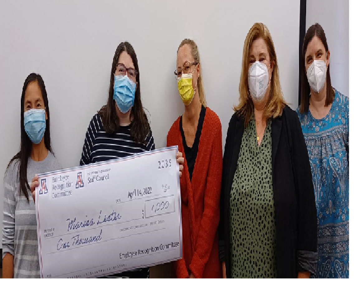 Group image of people displaying a big check they received